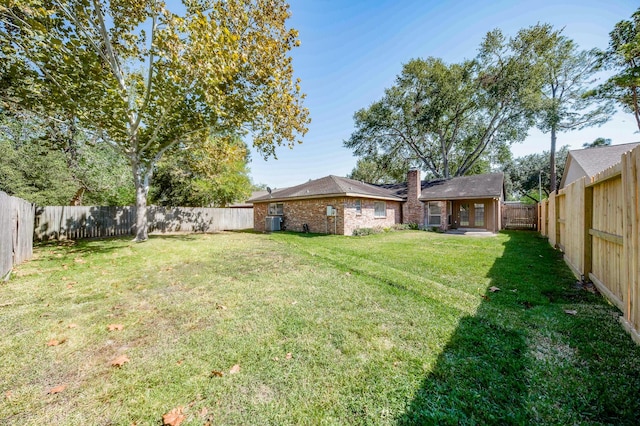 view of yard with a fenced backyard and cooling unit