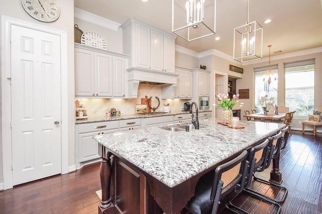 kitchen featuring crown molding, dark wood-style flooring, decorative backsplash, and a sink