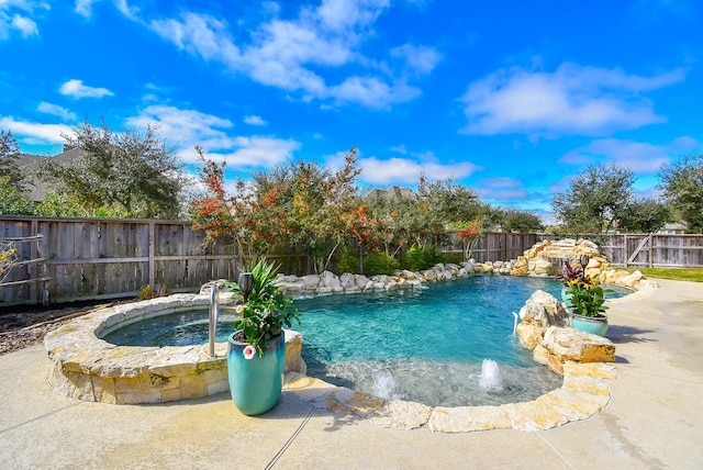 view of swimming pool with a fenced backyard, a fenced in pool, and an in ground hot tub