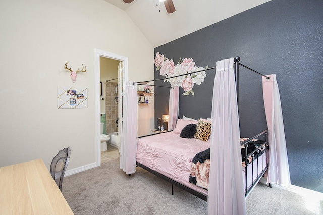 carpeted bedroom featuring lofted ceiling, baseboards, a ceiling fan, and ensuite bathroom