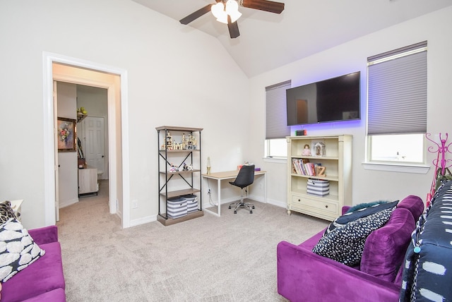 interior space with lofted ceiling, a ceiling fan, a wealth of natural light, and baseboards