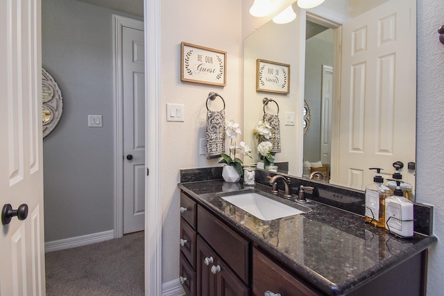 bathroom featuring vanity and baseboards