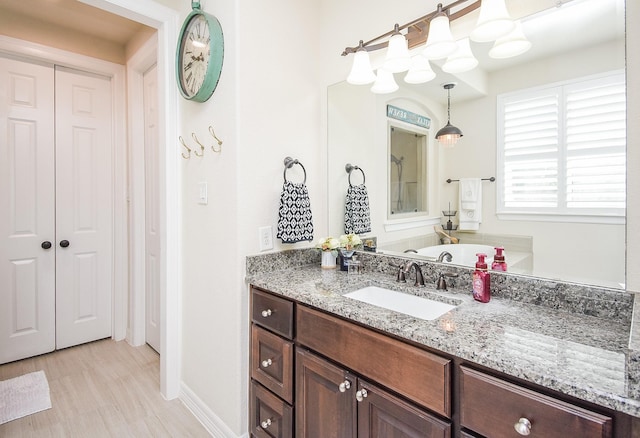 full bath with baseboards and vanity