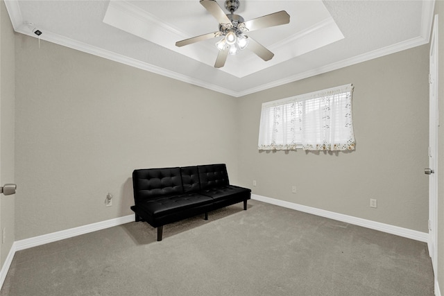 sitting room featuring ornamental molding, carpet, a raised ceiling, and baseboards