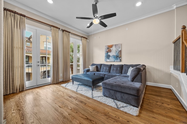 living area featuring baseboards, wood finished floors, crown molding, french doors, and recessed lighting