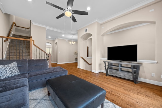 living area featuring visible vents, stairway, wood finished floors, and recessed lighting