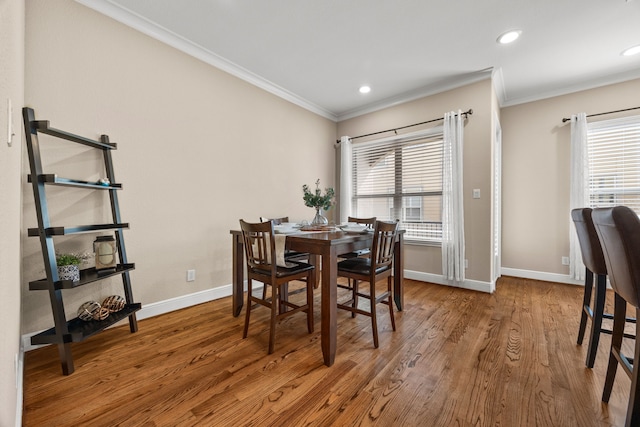 dining area with ornamental molding, recessed lighting, wood finished floors, and baseboards