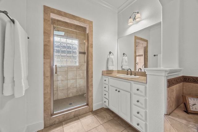 bathroom featuring a stall shower, tile patterned floors, ornamental molding, and vanity