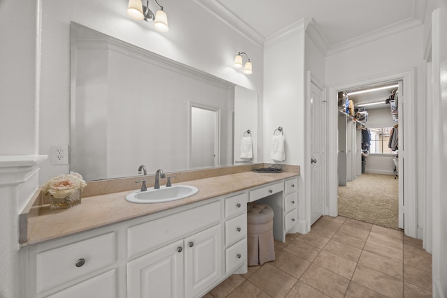 bathroom featuring tile patterned flooring, crown molding, and vanity