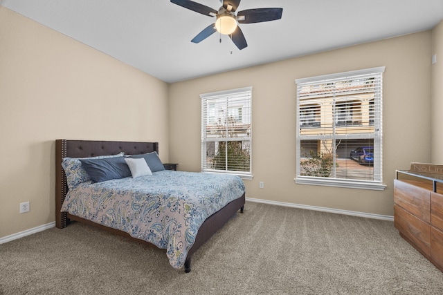 carpeted bedroom with ceiling fan and baseboards