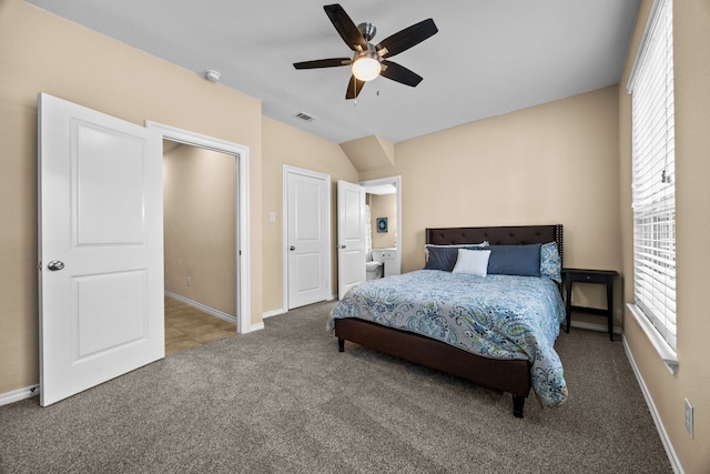 bedroom with vaulted ceiling, carpet, visible vents, and baseboards