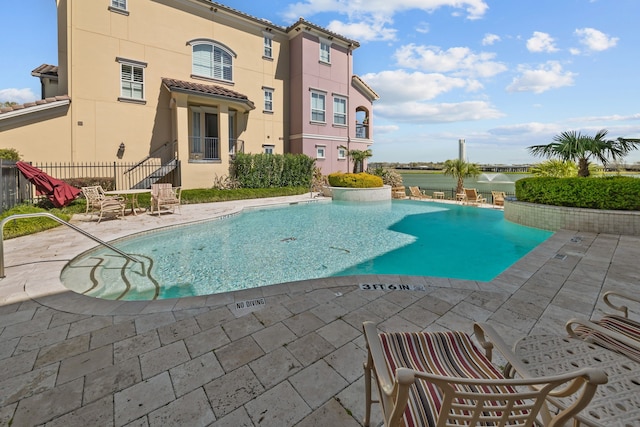 pool featuring a patio area and fence