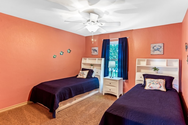 carpeted bedroom featuring ceiling fan and baseboards