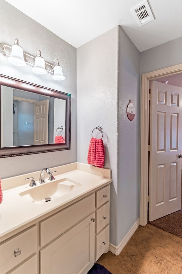 bathroom with visible vents, vanity, and baseboards