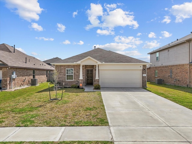 view of front of property with a garage, central AC, and a front yard