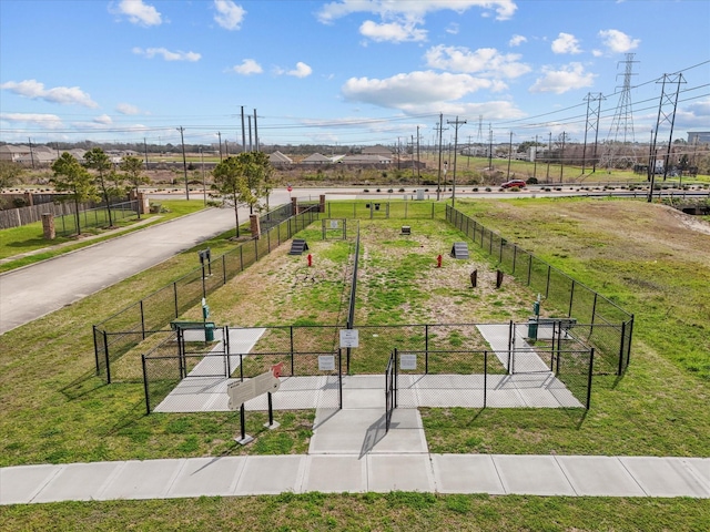 surrounding community with a gate, fence, and a lawn