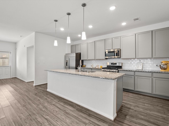 kitchen with dark wood finished floors, appliances with stainless steel finishes, gray cabinets, and visible vents