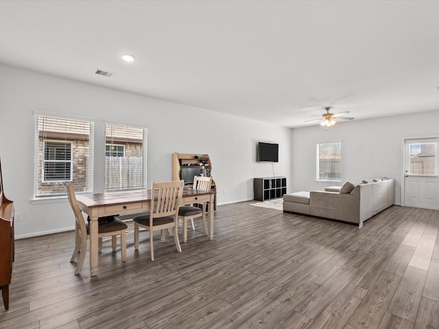 dining space with recessed lighting, visible vents, a ceiling fan, wood finished floors, and baseboards