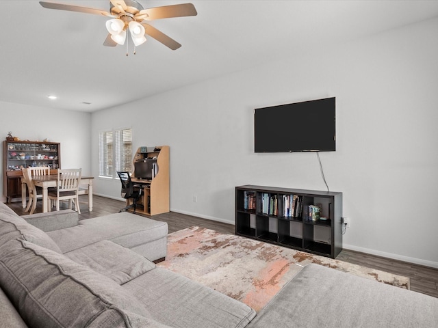 living area featuring ceiling fan, wood finished floors, and baseboards