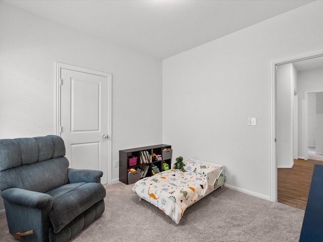 carpeted bedroom featuring baseboards