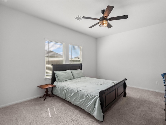 bedroom with light carpet, ceiling fan, and baseboards