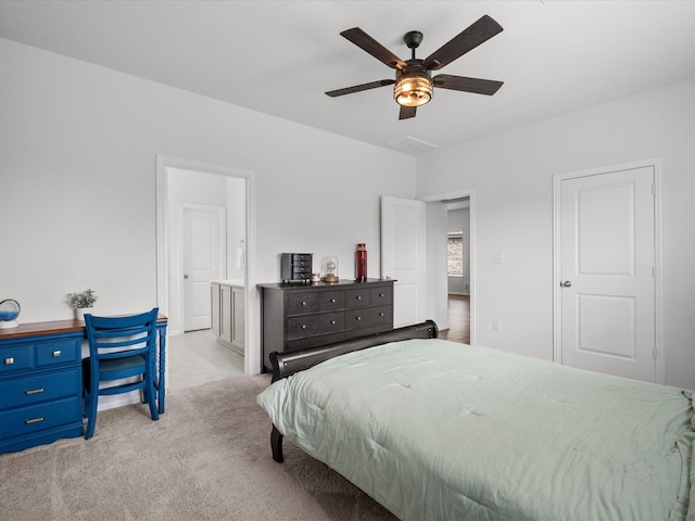 bedroom featuring carpet floors, ceiling fan, and ensuite bath