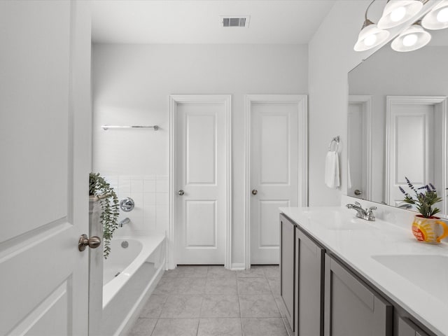 full bath with a garden tub, a sink, visible vents, and tile patterned floors