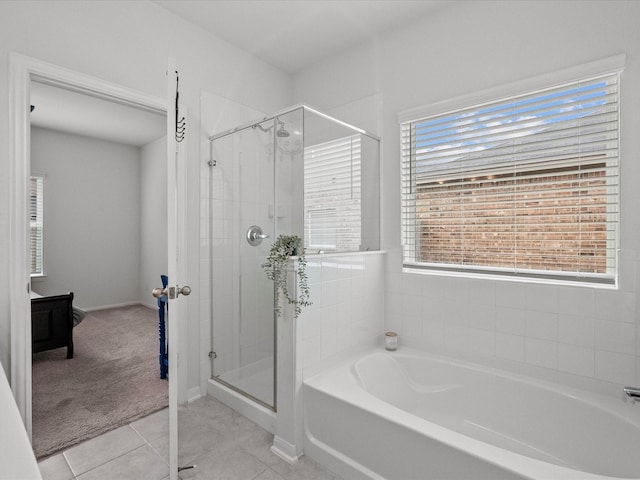 full bath with a garden tub, a shower stall, and tile patterned flooring