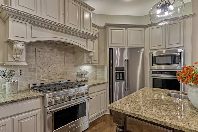 kitchen with tasteful backsplash, high end appliances, custom range hood, light stone counters, and dark wood-style flooring