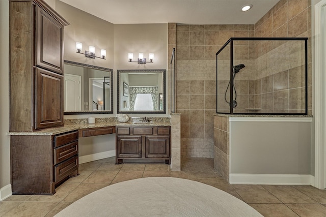 bathroom featuring tile patterned floors, vanity, and walk in shower