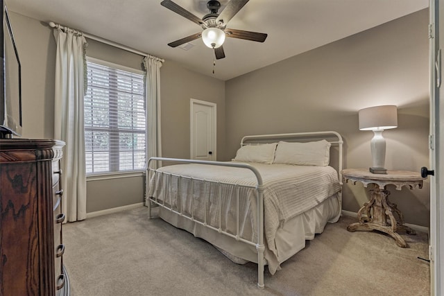 bedroom featuring light carpet, ceiling fan, and baseboards