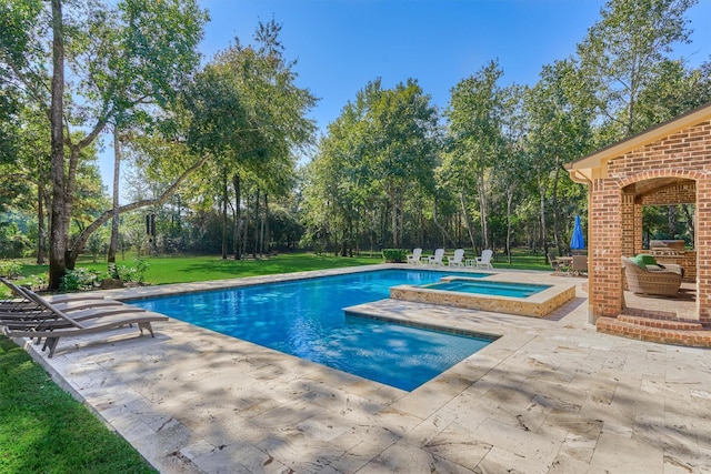 pool featuring a patio, a yard, and an in ground hot tub