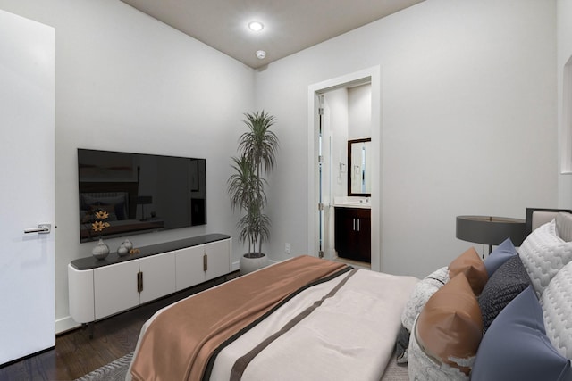 bedroom with ensuite bath, wood finished floors, and recessed lighting