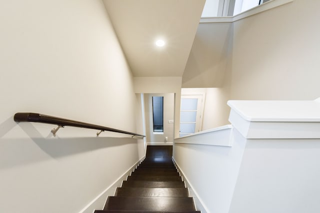 staircase with recessed lighting, baseboards, and wood finished floors