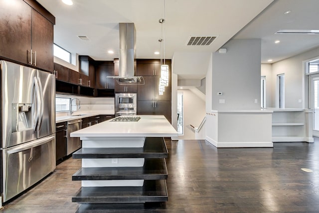 kitchen with island exhaust hood, stainless steel appliances, light countertops, visible vents, and dark brown cabinets