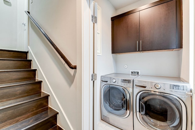 clothes washing area with cabinet space and washer and dryer