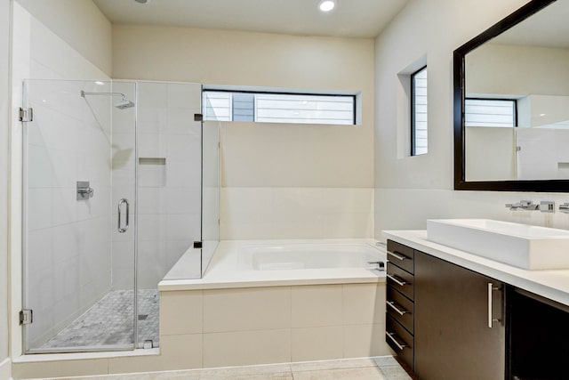 bathroom featuring recessed lighting, a garden tub, a shower stall, and vanity