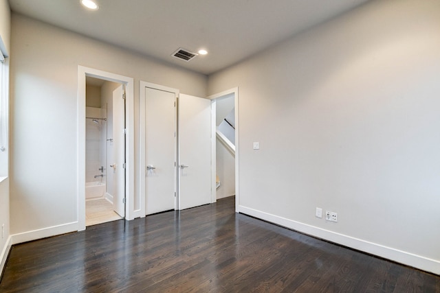 unfurnished bedroom with baseboards, dark wood-style flooring, and recessed lighting