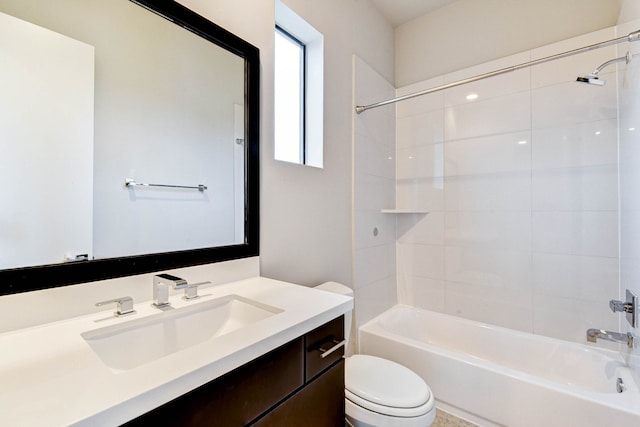 bathroom with washtub / shower combination, vanity, and toilet