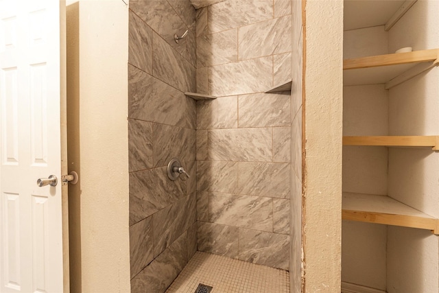 bathroom with tiled shower