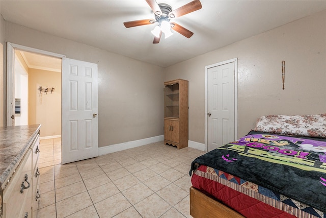 bedroom with light tile patterned floors, a ceiling fan, and baseboards