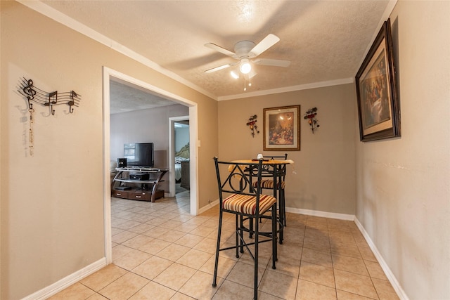 dining area featuring light tile patterned floors, a textured ceiling, a ceiling fan, and baseboards