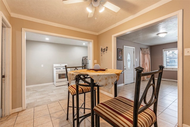 dining room with light tile patterned floors, a textured ceiling, and baseboards