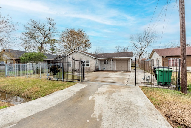 view of front facade with a fenced front yard, a garage, driveway, a gate, and a front yard