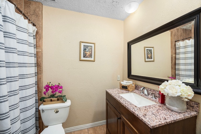 full bathroom with baseboards, a textured wall, toilet, a textured ceiling, and vanity