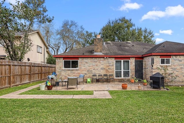 back of house with a chimney, a lawn, fence, and a patio