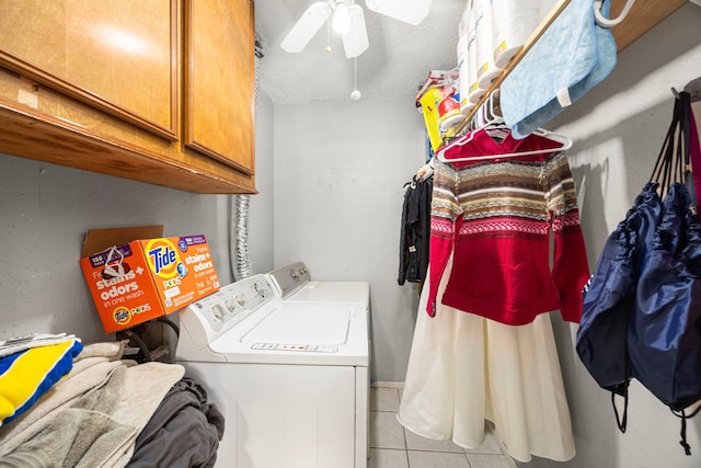 washroom featuring light tile patterned floors, a textured ceiling, washing machine and dryer, a ceiling fan, and cabinet space