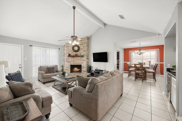 living room featuring beam ceiling, visible vents, a fireplace, and light tile patterned flooring