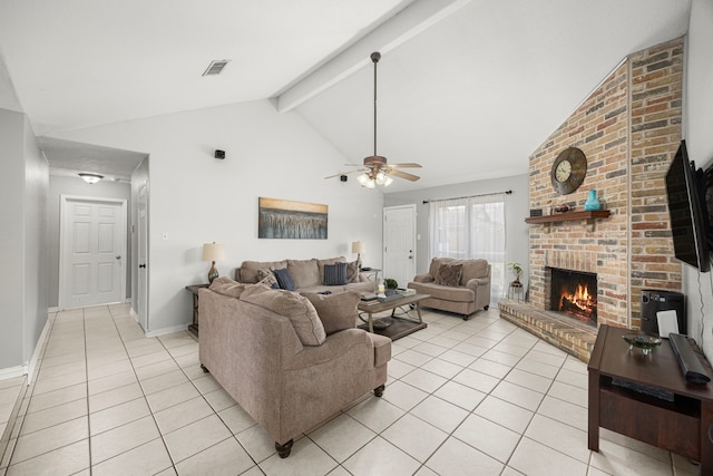 living area with a brick fireplace, beam ceiling, visible vents, and light tile patterned flooring