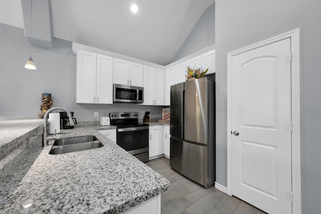 kitchen featuring stainless steel appliances, white cabinetry, and a sink